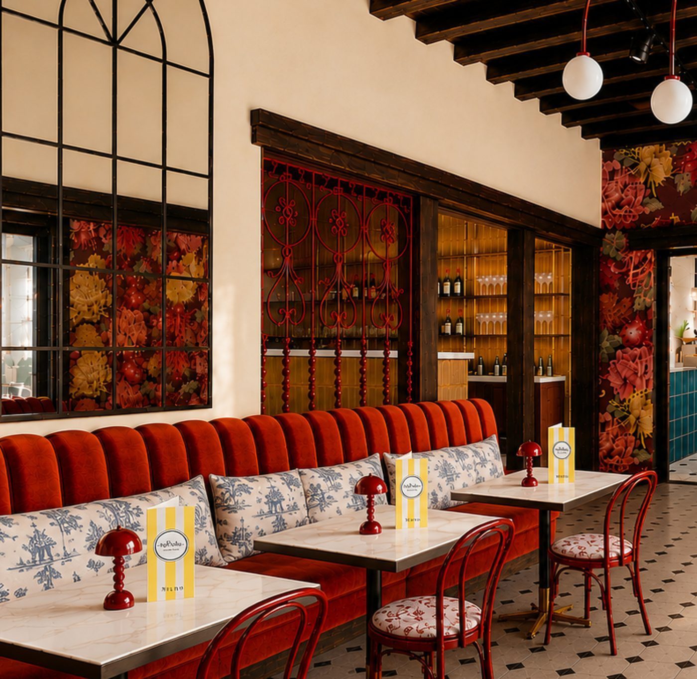 The finished Bij Belle interior — dark timber, wrought iron and orange velvet booths