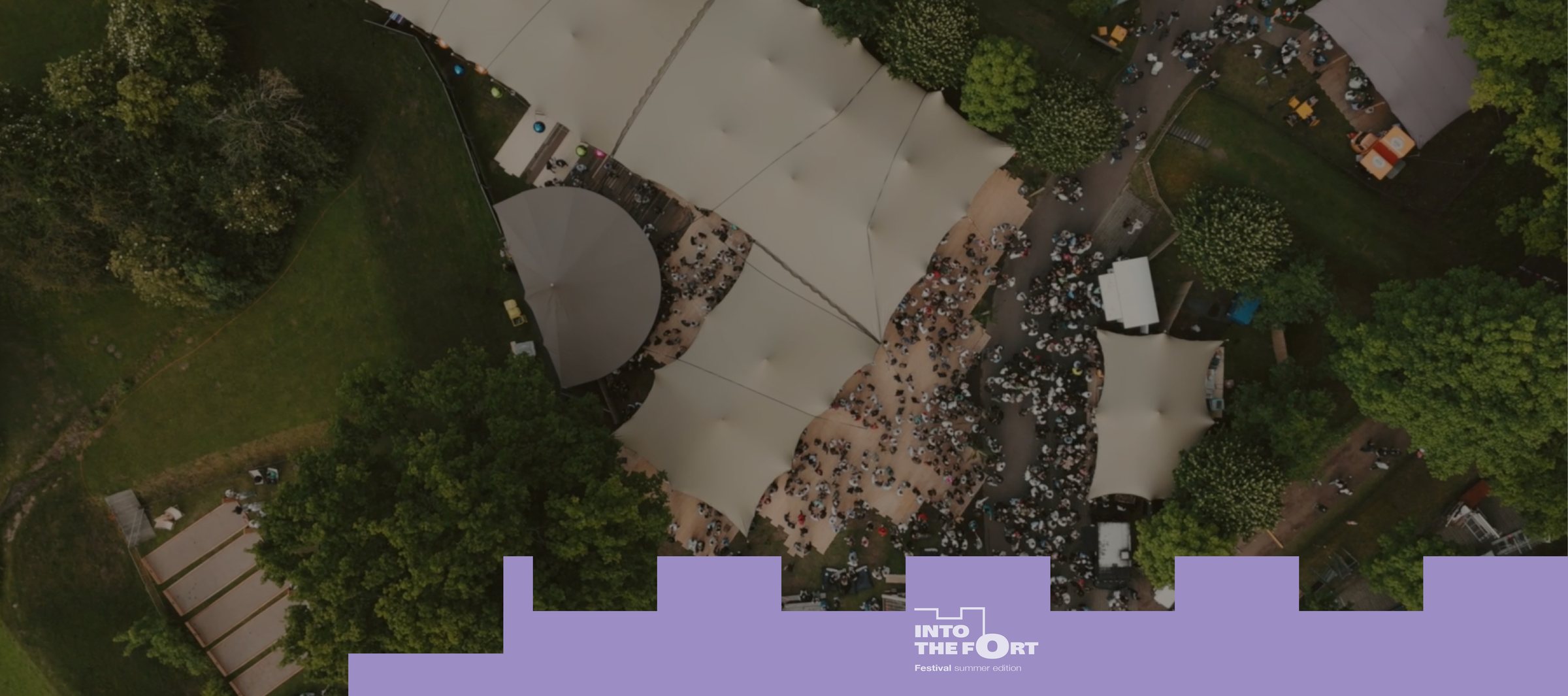 Aerial view of the Into the Fort festival tents and crowd, with the Into the Fort brand mark