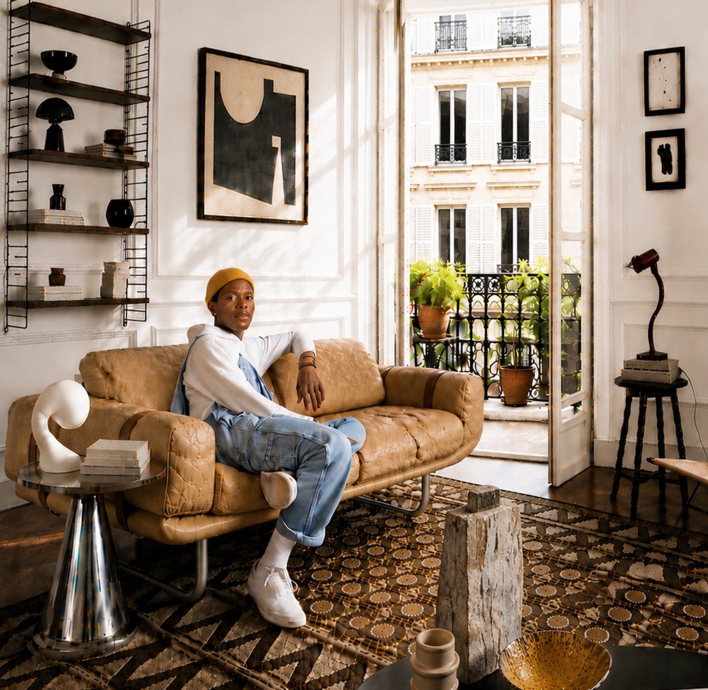 A guest relaxing on a Meyowi vintage leather sofa in a sunlit Paris apartment